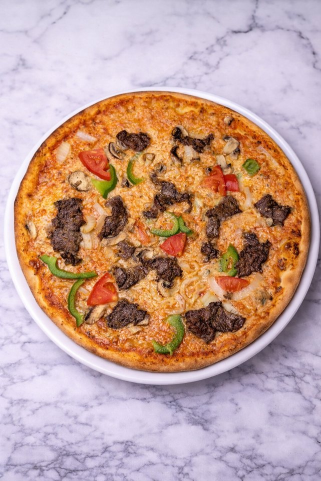 Oxfilé special – Pizza med oxfilé, färska champinjoner, paprika, tomater och lök på en bas av tomatsås och ost